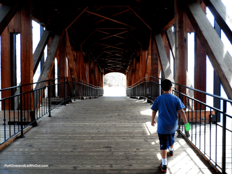 Boy walking across a covered bridge Old Salem, NC PullOverAndLetMeOut