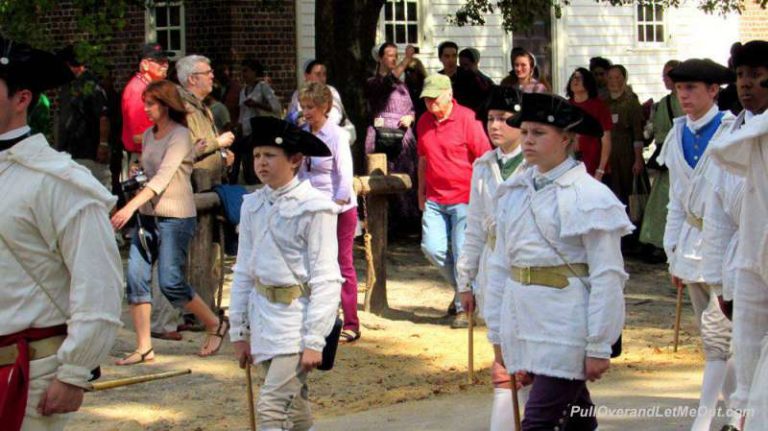 A fife and drum band marching through Colonial Williamsburg