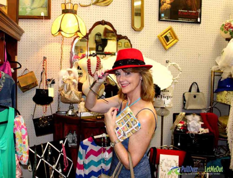 woman trying on a red hat